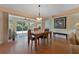 Cozy dining area featuring a chandelier, wood flooring, and sliding glass door to outdoor space at 3783 Wildcat Run, Lakeland, FL 33810