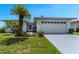 Charming single-story home with a well-maintained lawn, tropical landscaping, and an attached two-car garage at 3783 Wildcat Run, Lakeland, FL 33810