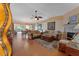 Open-concept living area with wood floors, comfortable seating, and a seamless transition to the dining area at 3783 Wildcat Run, Lakeland, FL 33810