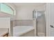Bright bathroom showcasing a modern tub, glass enclosed shower, and window at 3787 Sandhill Crane Dr, Lakeland, FL 33811