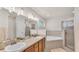 Bathroom featuring a double vanity, bathtub, and glass-enclosed shower at 3787 Sandhill Crane Dr, Lakeland, FL 33811