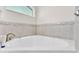 Close up of a bathtub featuring tilework and modern fixtures at 3787 Sandhill Crane Dr, Lakeland, FL 33811
