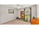 Bedroom features a ceiling fan, a large window and a vintage wooden desk at 3787 Sandhill Crane Dr, Lakeland, FL 33811