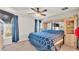 Primary bedroom features a ceiling fan, a large window, and a decorative cabinet at 3787 Sandhill Crane Dr, Lakeland, FL 33811
