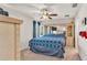 Spacious primary bedroom features a ceiling fan and a decorative blue and white comforter at 3787 Sandhill Crane Dr, Lakeland, FL 33811