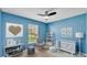 Bedroom with light blue walls, white furniture and decorations and a ceiling fan at 3787 Sandhill Crane Dr, Lakeland, FL 33811