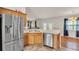 Kitchen with stainless steel appliances, wooden cabinets, and breakfast bar seating area at 3787 Sandhill Crane Dr, Lakeland, FL 33811