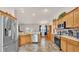 Kitchen view featuring stainless steel appliances, wooden cabinets, and breakfast bar at 3787 Sandhill Crane Dr, Lakeland, FL 33811