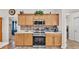 Modern kitchen with stainless steel appliances, including a range, microwave, and tile backsplash at 3787 Sandhill Crane Dr, Lakeland, FL 33811