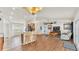 Open-concept living room with fireplace, kitchen bar, and hardwood floors offer modern comfort at 3787 Sandhill Crane Dr, Lakeland, FL 33811