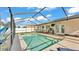 Screened in pool with patio furniture, and surrounding fence at 3787 Sandhill Crane Dr, Lakeland, FL 33811