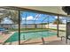 Backyard pool area with an enclosed screen featuring chairs for relaxing outdoors at 3787 Sandhill Crane Dr, Lakeland, FL 33811