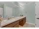 Bathroom featuring a double vanity with white sinks and a large mirror at 4309 Shipp Ct, Lakeland, FL 33813