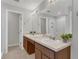 Bathroom featuring a double vanity with modern fixtures and a glass-enclosed shower with white tiling at 4309 Shipp Ct, Lakeland, FL 33813