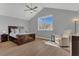 Bright and airy bedroom with vaulted ceilings, hardwood floors, a large window and a seating area at 4309 Shipp Ct, Lakeland, FL 33813