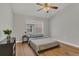 Bedroom with hardwood floors, a large window, and a ceiling fan at 4309 Shipp Ct, Lakeland, FL 33813