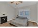 Bedroom with hardwood floors, a large window, and a ceiling fan at 4309 Shipp Ct, Lakeland, FL 33813