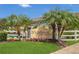 Community sign at Lake Highland entrance with lush landscaping, palm trees, and a decorative water feature at 4309 Shipp Ct, Lakeland, FL 33813