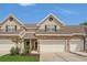 Charming townhouse featuring stone accents, attached garages and well maintained landscaping under a bright blue sky at 4309 Shipp Ct, Lakeland, FL 33813
