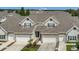 Charming townhome exterior with a two-car garage, stone accents, and a well-manicured front yard at 4309 Shipp Ct, Lakeland, FL 33813