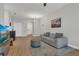 Well-lit living room features hardwood floors, neutral paint, modern furniture and a mounted TV at 4309 Shipp Ct, Lakeland, FL 33813