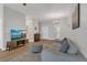 Well-lit living room features hardwood floors, neutral paint, modern furniture and a mounted TV at 4309 Shipp Ct, Lakeland, FL 33813
