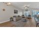 Bright living room with hardwood floors, neutral paint, modern furniture, ceiling fan and natural light at 4309 Shipp Ct, Lakeland, FL 33813