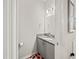 Powder room featuring a granite vanity, modern fixtures, and cherry-themed decor on hardwood floor at 4340 Reding Way, Lakeland, FL 33813