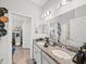 Bathroom with double sinks, granite countertop, and adjacent views of a bedroom for easy supervision at 4340 Reding Way, Lakeland, FL 33813
