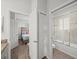 Hallway view of a bedroom, closet, and bathroom with glass door and tiled walls for a modern touch at 4340 Reding Way, Lakeland, FL 33813