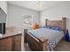 A bedroom offers a wooden bed frame, natural light, and a matching wooden dresser at 4340 Reding Way, Lakeland, FL 33813