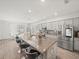 Bright kitchen showcasing an island with bar seating, stainless steel appliances, and dining area at 4340 Reding Way, Lakeland, FL 33813
