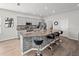 Modern eat-in kitchen boasts an island with bar seating, gray cabinets, and stainless steel appliances at 4340 Reding Way, Lakeland, FL 33813