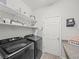 Well-organized laundry room with modern washer and dryer and open shelving at 4340 Reding Way, Lakeland, FL 33813