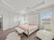 Light filled main bedroom with a four poster bed, hardwood flooring, and white accents for a serene space at 4340 Reding Way, Lakeland, FL 33813