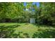 An enclosed shed sits nestled between lush greenery, creating a private storage solution at 4908 S Bedford Ln, Lakeland, FL 33813