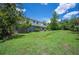 The large, green backyard is complete with landscaping, shed, and the back of the house visible at 4908 S Bedford Ln, Lakeland, FL 33813