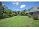 Expansive green backyard, with mature trees, lush landscaping, and shed, offering a serene outdoor retreat at 4908 S Bedford Ln, Lakeland, FL 33813