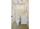 Cozy bathroom features floral wallpaper, tiled floor, and updated vanity with globe lighting at 4908 S Bedford Ln, Lakeland, FL 33813