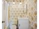 Bathroom featuring stylish wallpaper and a white vanity and lighting at 4908 S Bedford Ln, Lakeland, FL 33813