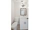 Modern bathroom featuring a sleek vanity, toilet, and updated lighting fixture at 4908 S Bedford Ln, Lakeland, FL 33813