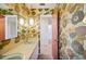 Bathroom with retro wallpaper, double sinks, and unique pendant lighting at 4908 S Bedford Ln, Lakeland, FL 33813