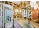Bathroom with retro wallpaper, double sinks, and unique pendant lighting at 4908 S Bedford Ln, Lakeland, FL 33813