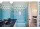 Bathroom featuring blue tiling, unique wallpaper, and a walk-in tub at 4908 S Bedford Ln, Lakeland, FL 33813
