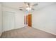 Bright bedroom featuring carpet floors, ceiling fan, and closet with louvered doors at 4908 S Bedford Ln, Lakeland, FL 33813