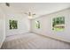 Spacious bedroom with plush carpeting and large windows providing plenty of natural light at 4908 S Bedford Ln, Lakeland, FL 33813
