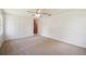 Bright bedroom featuring carpet floors, ceiling fan, and closet with louvered doors at 4908 S Bedford Ln, Lakeland, FL 33813