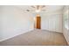 Spacious bedroom featuring carpet floors, a ceiling fan, and built-in closet with louvered doors at 4908 S Bedford Ln, Lakeland, FL 33813