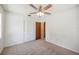 Bright bedroom featuring carpet floors, ceiling fan, and closet with louvered doors at 4908 S Bedford Ln, Lakeland, FL 33813