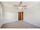 Bright bedroom featuring carpet floors, ceiling fan, and closet with louvered doors at 4908 S Bedford Ln, Lakeland, FL 33813